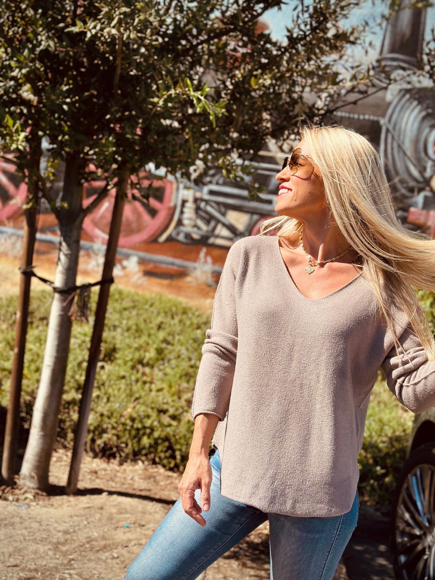Woman walking outdoors with trees and a scenic background