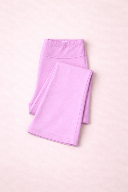 Folded pink leggings on a pink background