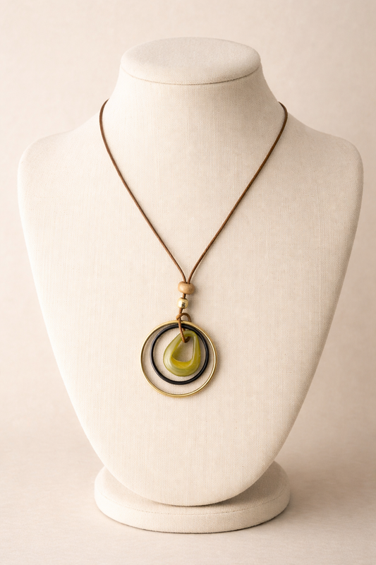 Necklace with a circular pendant on a mannequin bust against a plain background